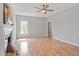 Spacious living room with fireplace, ceiling fan, and laminate wood flooring at 6863 Paint Rock Ln, Raleigh, NC 27610