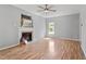 Spacious living room with fireplace, ceiling fan, and laminate wood flooring at 6863 Paint Rock Ln, Raleigh, NC 27610