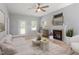Open living room with wood floors, neutral paint, and ample seating enhanced by natural light at 6863 Paint Rock Ln, Raleigh, NC 27610