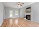 Spacious living room with fireplace, ceiling fan, and ample natural light at 6863 Paint Rock Ln, Raleigh, NC 27610