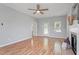 Spacious living room with fireplace, ceiling fan, and back door to exterior at 6863 Paint Rock Ln, Raleigh, NC 27610