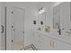 A modern bathroom with a double vanity, quartz countertops, and contemporary fixtures at 700 W North St # 101, Raleigh, NC 27603