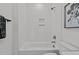 Shower-tub combo in a white tiled bathroom with built-in niche at 700 W North St # 101, Raleigh, NC 27603