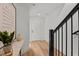 Bright entryway featuring light hardwood floors, a white door, black stair railing, and tasteful decor at 700 W North St # 101, Raleigh, NC 27603