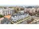 An eye-level aerial view displays modern townhomes with landscaped yards in an urban setting at 700 W North St # 101, Raleigh, NC 27603