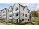 Modern townhouse exterior showcasing grey and white siding, black framed windows, and well-maintained landscaping at 700 W North St # 101, Raleigh, NC 27603
