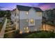 Two-story townhouse exterior with gray and white siding, black framed windows, and manicured landscaping at 700 W North St # 101, Raleigh, NC 27603