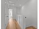 Bright hallway featuring wood floors, white walls, and modern doors at 700 W North St # 101, Raleigh, NC 27603