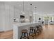 Open kitchen with a large island, pendant lighting, and seating at 700 W North St # 101, Raleigh, NC 27603