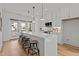 Elegant white kitchen with a large island, counter stools, and stainless steel appliances at 700 W North St # 101, Raleigh, NC 27603