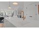Close up of the kitchen island featuring a gold faucet and white quartz countertops at 700 W North St # 101, Raleigh, NC 27603