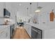 Bright, open kitchen with white cabinets, a quartz island, and modern stainless steel appliances at 700 W North St # 101, Raleigh, NC 27603