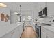 Open concept kitchen with stainless steel appliances, quartz countertops, and white shaker cabinets at 700 W North St # 101, Raleigh, NC 27603