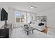 Cozy living room with a white sofa, natural light, and modern decor at 700 W North St # 101, Raleigh, NC 27603