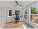 Bright home office with modern desk, ample natural light, and a relaxing ceiling fan at 700 W North St # 101, Raleigh, NC 27603