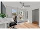 Bright home office with modern desk, ample natural light, and a relaxing ceiling fan at 700 W North St # 101, Raleigh, NC 27603