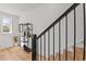 A contemporary staircase features black metal railings and light wood steps, leading to a bright, airy space at 700 W North St # 101, Raleigh, NC 27603