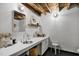 Chic bathroom with a large vanity, decorative mirror, and exposed wood beam ceiling at 701 W Trinity Ave # 116, Durham, NC 27701