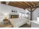 Bedroom features a queen-size bed, exposed wood beams, and comfortable furnishings at 701 W Trinity Ave # 116, Durham, NC 27701