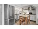 Modern kitchen with stainless steel appliances, white cabinets, and a breakfast nook at 701 W Trinity Ave # 116, Durham, NC 27701