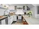 Modern kitchen featuring white cabinets, stainless steel appliances, and granite countertops at 701 W Trinity Ave # 116, Durham, NC 27701