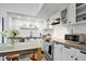 Bright kitchen featuring white cabinets, stainless steel appliances, and granite countertops at 701 W Trinity Ave # 116, Durham, NC 27701