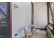 Charming porch area with seating, shielded by screen door and outdoor security light at 701 W Trinity Ave # 116, Durham, NC 27701
