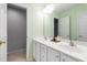Bright bathroom features double vanity, neutral countertop, and large mirror on a painted wall at 704 Voyager Pl, Durham, NC 27712
