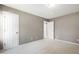 Bedroom with neutral walls, plush carpet, and white doors leading to other rooms at 704 Voyager Pl, Durham, NC 27712