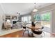 Dining area features wood floors, a table with seating, and sliding glass doors to a deck at 704 Voyager Pl, Durham, NC 27712