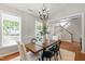 Well-lit dining area with wood table, stylish chandelier, and wainscoting at 704 Voyager Pl, Durham, NC 27712