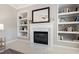 Elegant fireplace with marble surround and custom built-in bookshelves at 704 Voyager Pl, Durham, NC 27712