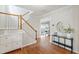 Inviting foyer with hardwood floors, staircase, and elegant console table at 704 Voyager Pl, Durham, NC 27712