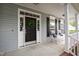 Inviting front porch with black door and white rocking chairs at 704 Voyager Pl, Durham, NC 27712
