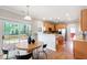 Eat-in kitchen boasts wood cabinets, granite counters, stainless appliances, and access to the deck at 704 Voyager Pl, Durham, NC 27712