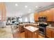 Open kitchen view featuring wood cabinets, stainless appliances, granite counters, and island at 704 Voyager Pl, Durham, NC 27712