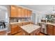 Spacious kitchen featuring ample wood cabinets, granite counters, and stainless steel appliances at 704 Voyager Pl, Durham, NC 27712
