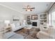 Bright living room with a fireplace, bookshelves, and neutral decor at 704 Voyager Pl, Durham, NC 27712