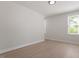 Bright bedroom with hardwood floors and neutral paint, featuring natural light from two large windows at 730 Hopkins St, Durham, NC 27701