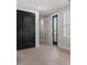 Cozy bedroom with hardwood floors, black closet doors, and a backyard view through the window at 730 Hopkins St, Durham, NC 27701
