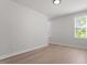 Bright bedroom with hardwood floors and neutral paint, featuring natural light from two large windows at 730 Hopkins St, Durham, NC 27701