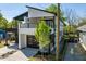 Modern two-story home with a stylish exterior, a two-car garage, and a charming front yard at 730 Hopkins St, Durham, NC 27701