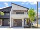 Modern two-story home with a sleek design, balcony, and a two-car garage showcasing contemporary curb appeal at 730 Hopkins St, Durham, NC 27701