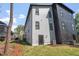 Modern two-story home with a combination of light gray and dark gray siding and black-trimmed windows at 730 Hopkins St, Durham, NC 27701