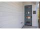 Charming front door featuring a contemporary design with sidelights and modern mailbox, offering curb appeal at 730 Hopkins St, Durham, NC 27701