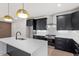 Modern kitchen features black cabinetry, stainless steel appliances, subway tile backsplash, and quartz countertops at 730 Hopkins St, Durham, NC 27701
