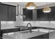 Modern kitchen features black cabinetry, stainless steel appliances, subway tile backsplash, and quartz countertops at 730 Hopkins St, Durham, NC 27701