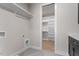 Convenient laundry room leads to a walk-in closet with custom shelving and wooden floors at 730 Hopkins St, Durham, NC 27701