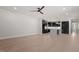 Open floorplan featuring kitchen and living space with modern light fixtures and hardwood floors throughout at 730 Hopkins St, Durham, NC 27701