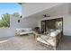 Relaxing outdoor patio featuring comfortable seating, ceiling fan, and sliding glass doors to the bedroom at 730 Hopkins St, Durham, NC 27701